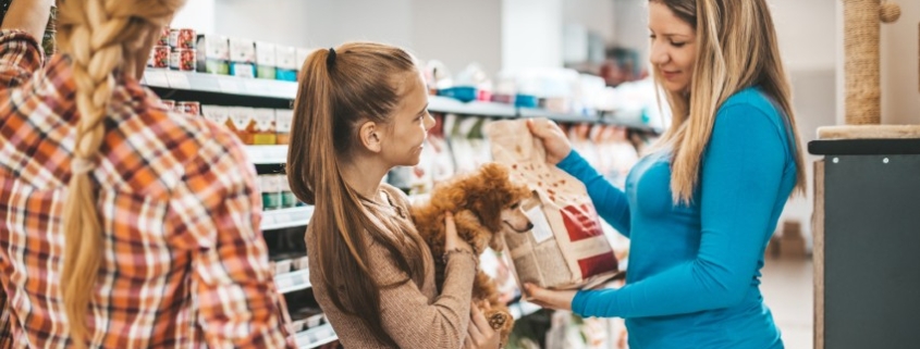 The pet owner is choosing high quality dog food for better nutrition